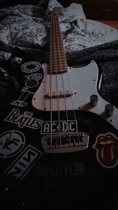 an electric guitar laying on top of a bed