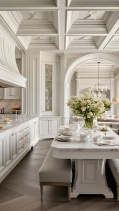 a large kitchen with white cabinets and an island in front of the stove top oven