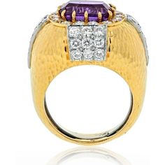 Discover a truly enchanting piece that will capture your heart and elevate your style. Introducing the David Webb 18K Yellow Gold Oval Amethyst and Diamond Hammered Finish Ring. Crafted with meticulous attention to detail, this ring exudes elegance and sophistication. The centerpiece of this exquisite ring is a mesmerizing cushion-shaped amethyst, measuring approximately 11.8mm x 9.5mm. Its vibrant purple hue is the epitome of luxury and will undoubtedly make a statement.Adding to the allure are Luxury White Gold Amethyst Ring With Gemstone Accents, Luxury White Gold Amethyst Ring, Luxury Amethyst Rings With Gemstone Accents, Luxury Yellow Gold Amethyst Ring With Gemstone Accents, Luxury White Gold Amethyst Ring With Diamond Accents, Luxury Oval Amethyst Diamond Ring, Luxury Polished Oval Amethyst Ring, Luxury Polished Amethyst Ring, Luxury Oval Amethyst Ring With Diamond Accents