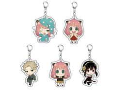 four keychais with anime characters on them, one has pink hair and the other has