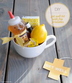 a cup filled with lemons, honey and other things to make it look like a bear