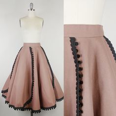 "Rare 1950s felt skirt by designer Melrod Ritter *Melrod Ritter designed as a hobby; her designs appeared in the windows of Berdorf's and Saks Fifth Avenue. One of her skirts appeared on the cover of Vogue 1951 on model Jeanne Patchett. She spent time with celebrities including Liz Taylor. Please DM us for photos! We obtained all information directly from Melrod Ritter's grandaughter! ~Taupe brown felted wool ~Black braided corde trim with velvet pom poms ~Side hook and eye closures ~Unlined Clean and ready to wear. Condition:  Very good. Faint spot on front/faint spots on side. Some bare spots/a few small holes and some holes that have been mended. Please DM for additional photos Size: Fits like a modern Medium *please consult measurements to ensure fit. Measurements Waist: 28\"(hooks cou Vintage Circle Skirt, Felt Skirt, Cover Of Vogue, 1950s Skirt, Designer Skirt, Liz Taylor, Elf Costume, Skirt Vintage, Wool Skirt