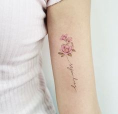 a woman with a pink flower tattoo on her arm