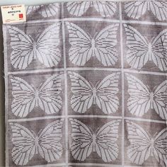 a piece of cloth with white butterflies on it