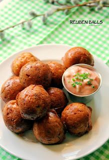 a white plate topped with tater tots next to a small bowl of dip