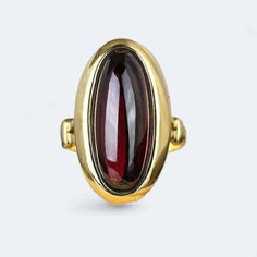 Introducing our exquisite Victorian Garnet Ring crafted in 9k yellow  gold weighing 5.8 grams. Adorned with a natural 4.5 ctw Garnet, this beautifully decorated ring is a perfect choice for an anniversary, engagement, or wedding. The radiant yellow finish adds a touch of warmth and sophistication, making it a timeless piece for her collection. Elevate your style with this unique and meticulously crafted ring, a celebration of love and elegance. Classic Domed Ruby Ring As Gift, Classic Domed Ruby Ring Gift, Formal Yellow Gold Cabochon Sapphire Ring, Heirloom Gemstone Dome Ring For Formal Occasions, Formal Heirloom Gemstone Dome Ring, Formal Heirloom Dome Ring With Gemstone, 14k Gold Cabochon Dome Ring For Anniversary, Classic Garnet Rings With Bezel Setting, Formal Yellow Gold Domed Sapphire Ring