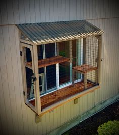 a chicken coop built into the side of a house