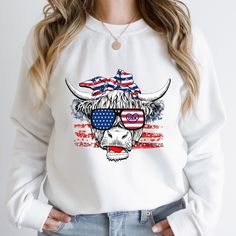 4th of July Sweatshirt, July 4th Sweater, 4th of July Shirt, Crewneck Sweater, Patriotic Shirt, USA, American Cow Shirt, American Flag A sturdy and warm crewneck sweatshirt bound to keep you warm in the colder months. A pre-shrunk, classic fit sweater that is super comfortable. This sweatshirt will make a great gift for Independence Day. * 50% cotton, 50% polyester  * Pre-shrunk * Classic fit Americana Long Sleeve Tops For 4th Of July, Long Sleeve Americana Tops For 4th Of July, Americana Long Sleeve Tops With American Flag Print, Long Sleeve Tops For 4th Of July, Patriotic American Flag Long Sleeve Tops, American Flag Tops For Fall, Long Sleeve Americana Tops With American Flag, Americana Style Long Sleeve Tops With American Flag, Long Sleeve Tops With American Flag