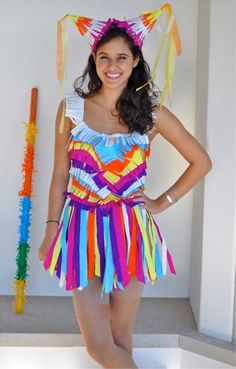 a woman in a colorful dress posing for the camera