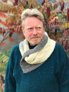 an older man wearing a knitted scarf