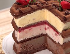 a chocolate cake with strawberries and cream on top is cut in half to show the layers