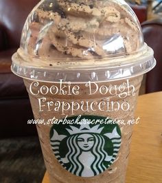 a starbucks cup with cookie dough and frappuccine in it sitting on a table