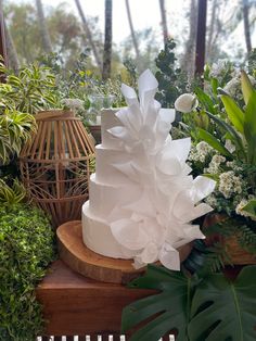 a large white cake sitting on top of a wooden table