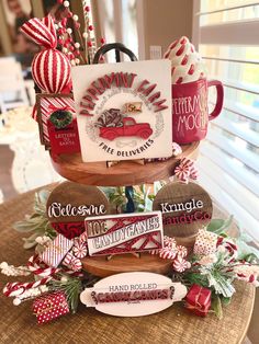 three tiered tray with candy canes and coffee mugs on it, all decorated in red and white