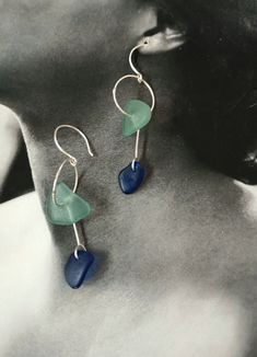 Buy me now or lose me forever! The sea glass in these beautiful handmade earrings is collected by us along the Mediterranean coast in Ibiza, Mallorca, and  the beaches around Barcelona. Each piece of sea glass that gets washed up on the shore is unique therefore colors, texture, and size do vary and that's why it creates a one of a kind piece of jewelry. Ocean - a Love story; is a tribute to recycling and our love to the great oceans that surround us. Our jewelry in sea glass tells a story of history and giving waste a new life! The Ocean collection is a mix of wanting to take advantage, beautify and recycle human waste. Is a one-of-a-kind, no one ever will be the same kind of jewelry. We use the broken glass that has been polished and shaped soft with the eternal movements by waves and sa Beach Earrings With Sea Glass And Ear Wire, Beach Sea Glass Earrings With Ear Wire, Handmade Blue Sea Glass Earrings, Beach Earrings With Recycled Glass And Ear Wire, Handmade Sea Glass Dangle Jewelry, Handmade Dangle Sea Glass Jewelry, Handmade Sea Glass Drop Earrings, Silver Sea Glass Earrings For Beach, Sea Glass Teardrop Earrings For Beach