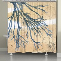 a shower curtain with blue branches on it in front of a bathtub and toilet