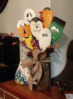 a vase filled with halloween decorations on top of a table