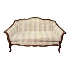 an antique style couch with wood trimmings and upholstered backrests