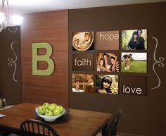 a dining room table with some apples on it and pictures on the wall behind it