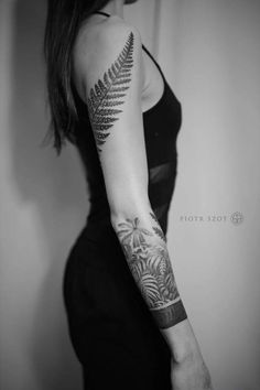 a woman with a fern tattoo on her arm