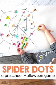 a young boy is playing with spider dots on a paper sheet and the text overlay reads, spider dots a preschool halloween game