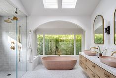 a bathroom with two sinks and a large bathtub