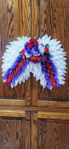 a close up of a wooden door with paper flowers on it