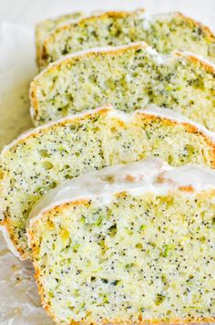 four slices of broccoli bread with white icing on top and green sprinkles