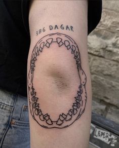 a person with a tattoo on their arm that reads 365 dagar and has a circular design in the middle