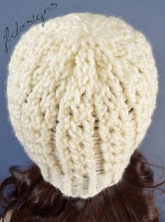 a woman's head wearing a white knitted hat