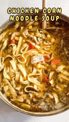 chicken corn noodle soup in a pan with a wooden spoon and title overlay reads chicken corn noodle soup