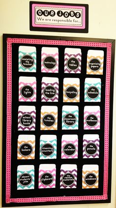 a bulletin board that has some words on it and is decorated with black, pink, blue, orange and white stripes