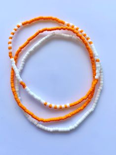 Set of 3 bracelets beaded on stretch cord. Orange Bead Bracelets For Beach, Orange Bracelet Beads For Beach, Orange Bead Bracelet For Beach, Orange Stretch Bracelet With Letter Beads, Hand-strung Orange Bracelets For Beach, Orange Hand-strung Beaded Bracelets For Beach, Orange Round Beads Friendship Bracelets For Beach, Orange Colorful Beads Friendship Bracelets For Summer, Orange Tiny Beads Bracelets For Summer