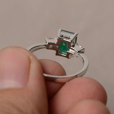 This is a gorgeous handmade creation. Its beauty is its simplicity & Elegance. The 6*8 mm emerald shape faceted lab emerald is crafted in solid sterling silver and with rhodium plated. All item is sent in a beautiful gift box If you have any idea of design your ring,pls contact me directly. You can realize more lovely stuff clicking the link https://www.etsy.com/shop/knightjewelry?refshopsection_shophome_leftnav Please leave the correct address and you phone number for delivering successfull Octagon Emerald Ring With Halo Setting, Octagon Emerald Ring With Diamond, Fine Jewelry Octagon Emerald Ring, Baguette Cut Solitaire Emerald Ring, May Birthstone Ring With Emerald Cut And Halo Setting, Emerald Ring With Center Stone In Baguette Cut, Emerald Ring With Baguette Cut Center Stone, Emerald Ring With Baguette Cut And Accent Stones, Solitaire Emerald Cut Emerald Promise Ring