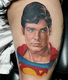 a man with a superman tattoo on his leg