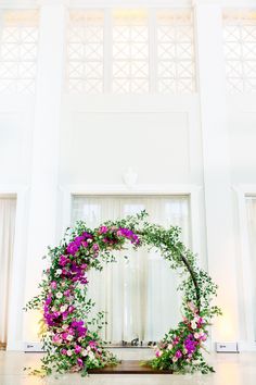 a wedding arch decorated with flowers and greenery