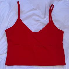 Perfect Condition, Never Worn. Super Cute Surplice Front That’s Very Flattering! Super Trendy Basic Top. Feel Free To Ask Any Questions! “Color: Red Style: Casual Pattern Type: Plain Type: Cami Neckline: Spaghetti Strap Length: Crop Fit Type: Slim Fit Fabric: Slight Stretch Material: Cotton Composition: 95% Cotton, 5% Spandex Care Instructions: Machine Wash Or Professional Dry Clean Chest Pad: No Padding Sheer: No Red Seamless Top For Spring, Red Seamless Cami Top, Red Seamless V-neck Top, Red Cami Crop Top For Spring, Red Cami Crop Top For Party, Red Seamless Crop Top Tank, Chic Red Cropped Tank Top, Trendy Red Crop Top With Built-in Bra, Red Tank Top With Built-in Bra For Night Out