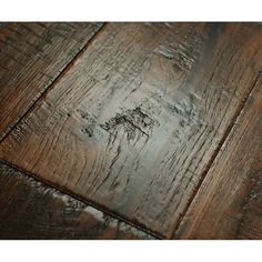 wood flooring that has been scratched and stained with dark brown stain on the top