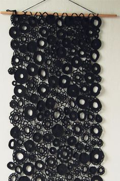 a wall hanging made out of black crochet