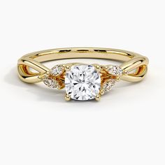 a yellow gold engagement ring with an oval center stone and two small diamonds on the band