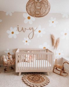 a baby's room with flowers on the wall and a wicker crib