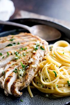 garlic butter pasta with grilled chicken on a plate