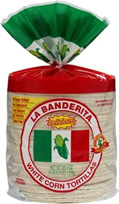 a bag of white corn tortillas on top of a red and green bag