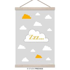 a poster hanging on a wall with clouds and the word's name in yellow