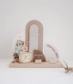 a wooden letter with flowers on it sitting next to a sign that says i love you