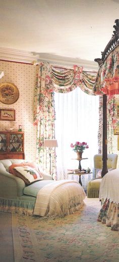 a bedroom with four poster bed and floral curtains