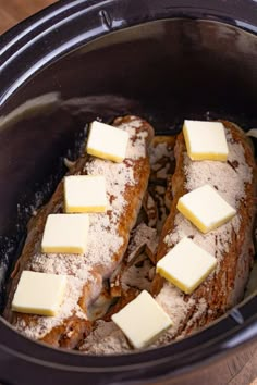 two pieces of bread with butter on top in a slow cooker