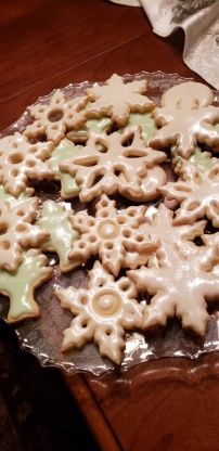 there are many cookies on the table ready to be cut and decorated into snowflakes