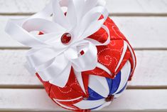 a red, white and blue ornament sitting on top of a wooden table