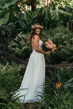 a woman in a wedding dress holding flowers